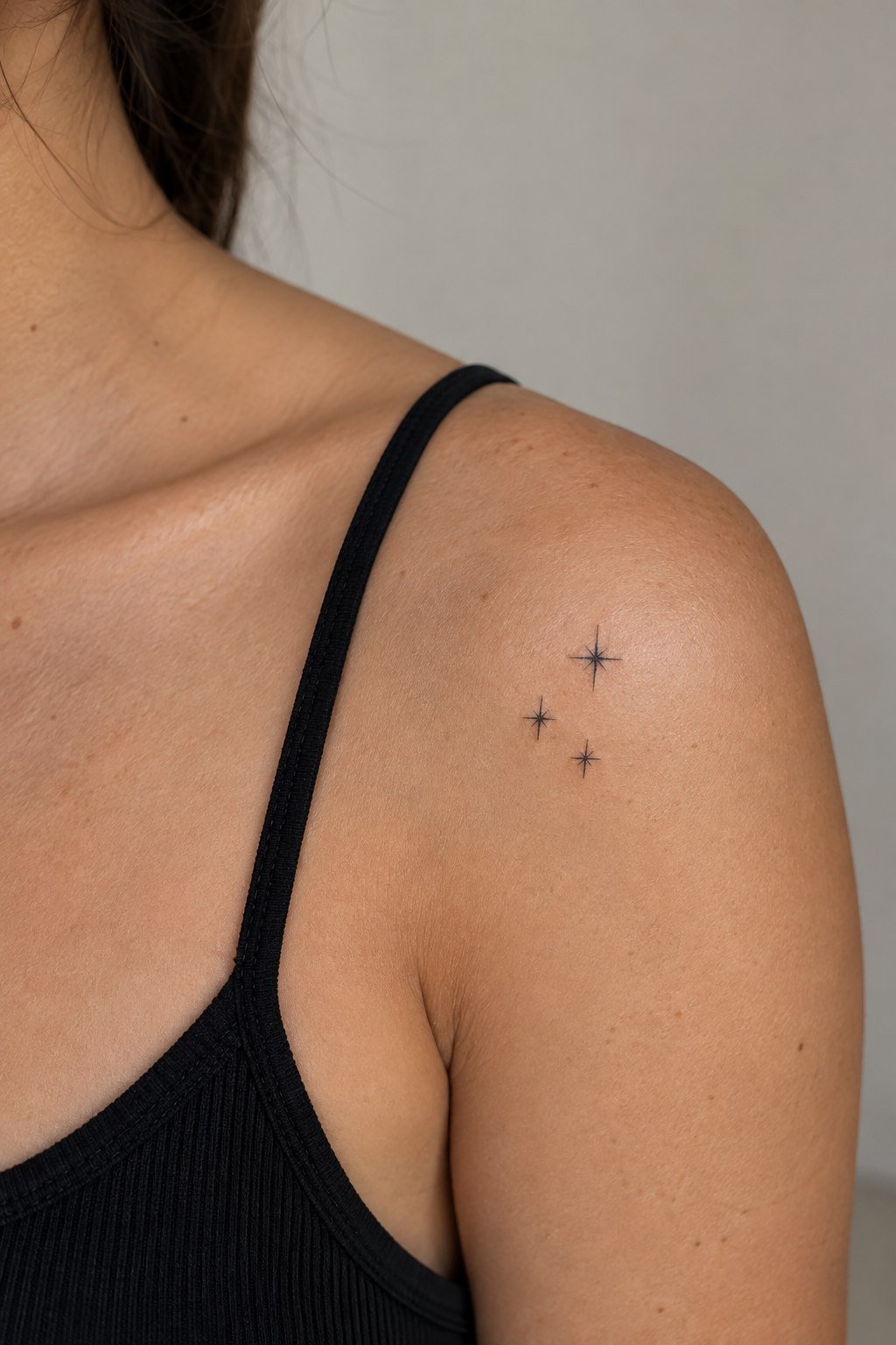 Minimal one-line wave tattoo on the inner wrist.