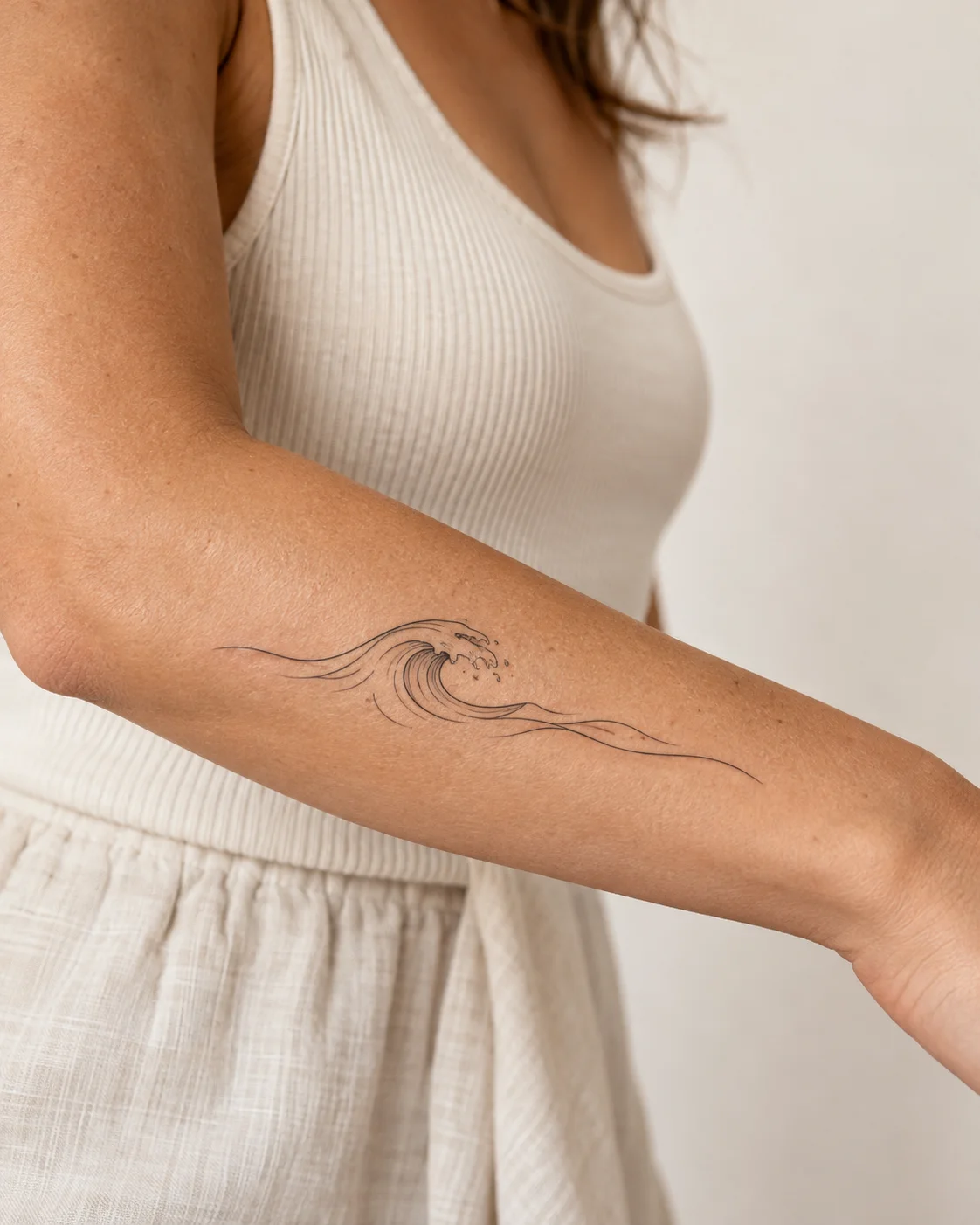 Gentle Ocean Wave fine line tattoo concept on the outer forearm