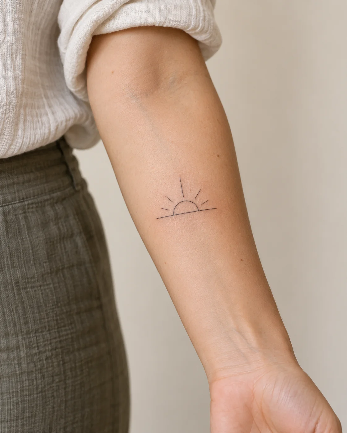 Simple Sun Above a Line fine line tattoo concept on the inner forearm