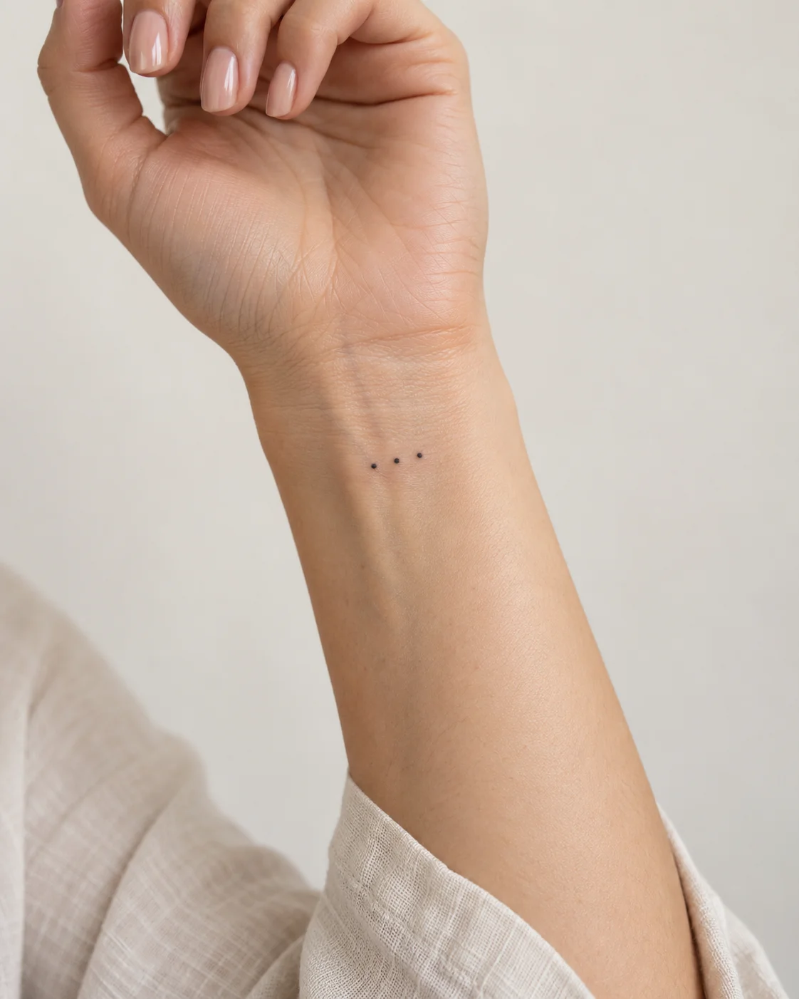 Three Spaced Dots fine line tattoo concept on the inner wrist